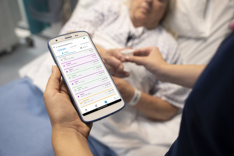 Clinician using Alairo HC50 at patient bedside