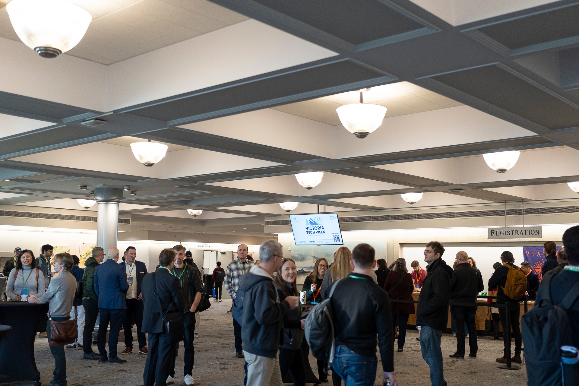[Conference organizers and attendees networking at a past event]